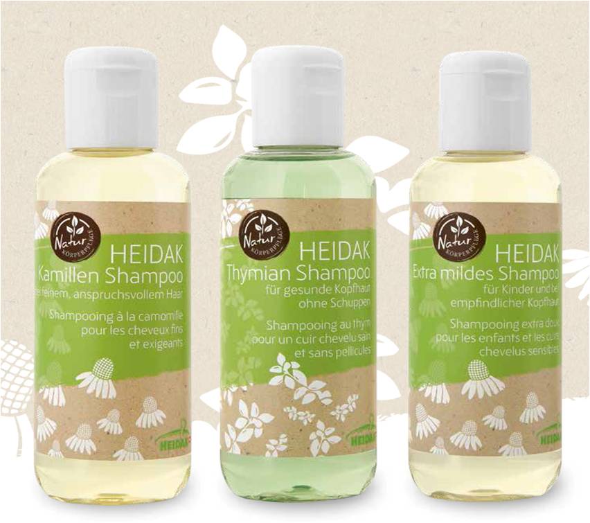 trois bouteilles de shampoing de la marque heidak aux plantes